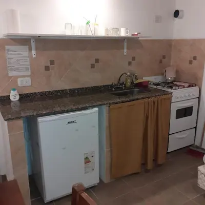 a kitchen with a sink and a stove at Posta Almendros Apart in Merlo