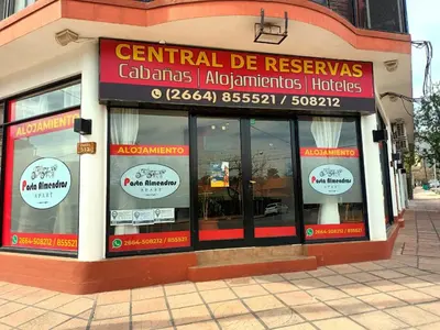 a store front of a building with signs on it at Posta Almendros Apart in Merlo