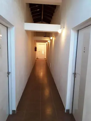 an empty hallway with a white wall and a ceiling at Posta Almendros Apart in Merlo