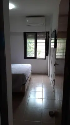 a bedroom with a bed and two windows at Departamento Temporario - Zona Centro in Cordoba