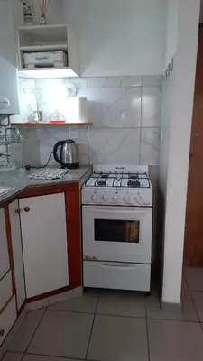 a kitchen with a white stove and a sink at Departamento Temporario - Zona Centro in Cordoba