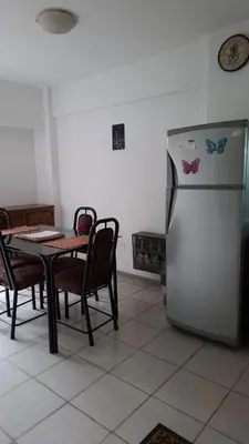 a kitchen with a table and a refrigerator at Departamento Temporario - Zona Centro in Cordoba