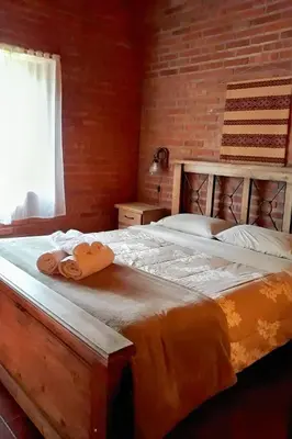 a bedroom with a bed with two towels on it at Complejo Entresierras in La Paz