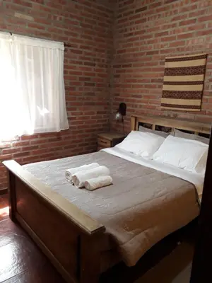a bedroom with a bed with towels on it at Complejo Entresierras in La Paz