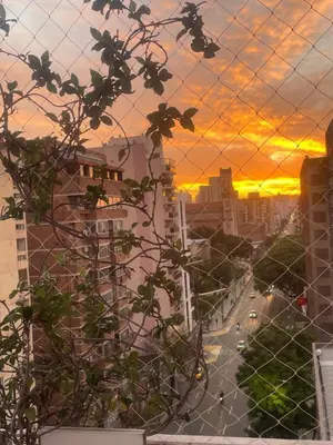a view of a city from a fence with a sunset in the background at Luminoso depto de 3 amplios dormitorios y living comedor, cochera gratuita in Cordoba