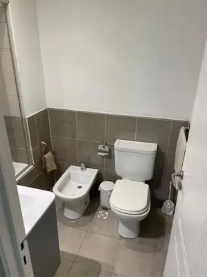a bathroom with a toilet and a sink at Departamento Nueva Cordoba in Cordoba