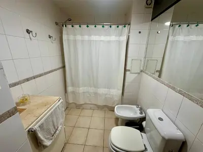a small bathroom with a toilet and a sink at Departamento Frente al Patio Olmos Shopping in Cordoba