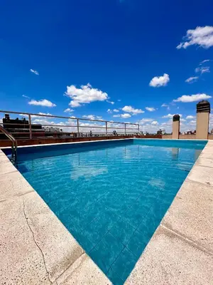 a swimming pool on the roof of a building at Departamento Frente al Patio Olmos Shopping in Cordoba