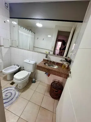 a bathroom with a toilet and a sink at Departamento Frente al Patio Olmos Shopping in Cordoba