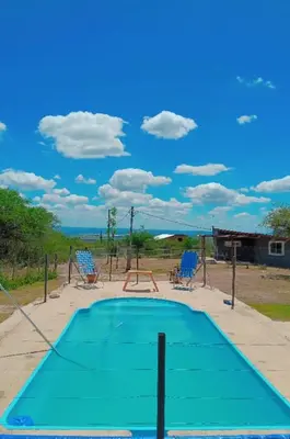 an empty playground with a trampoline and two chairs at Cabañas Entre Cerros in Merlo