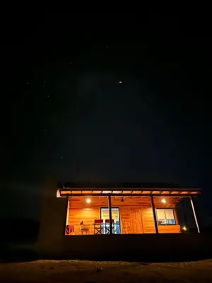 a house lit up at night with a patio at LaJu in Villa Yacanto