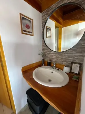 a bathroom with a sink and a mirror at LaJu in Villa Yacanto
