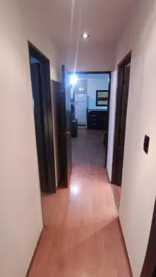 a hallway with two doors and a hard wood floor at Moderno y acogedor Depto Céntrico V Carlos Paz 200 m terminal Sobre Av San Martin in Villa Carlos Paz