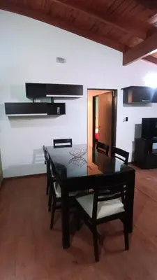 a dining room with a black table and chairs at Moderno y acogedor Depto Céntrico V Carlos Paz 200 m terminal Sobre Av San Martin in Villa Carlos Paz