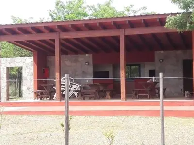a pavilion with tables and chairs and a zebra at Lago los Molinos Punto Claro villa Silvestre depto 2 dorm y cochera in Villa Ciudad Parque