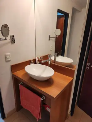 a bathroom with a white sink and a mirror at Lago los Molinos Punto Claro villa Silvestre depto 2 dorm y cochera in Villa Ciudad Parque