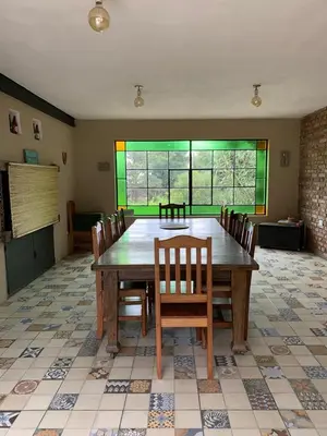 a dining room with a large wooden table and chairs at Hermosa casa de veraneo con pileta in Villa Carlos Paz