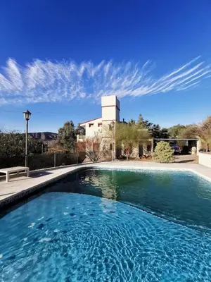 a swimming pool in front of a house at Hermosa casa de veraneo con pileta in Villa Carlos Paz