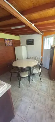 a dining room with a table and chairs in a room at Alojamiento Nonino in Villa Cura Brochero