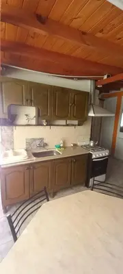 a kitchen with a sink and a stove at Alojamiento Nonino in Villa Cura Brochero