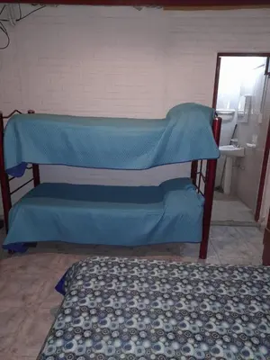 a room with a bed and a blue sheet at Alojamiento Nonino in Villa Cura Brochero