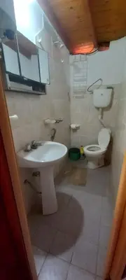 a bathroom with a sink and a toilet at Alojamiento Nonino in Villa Cura Brochero
