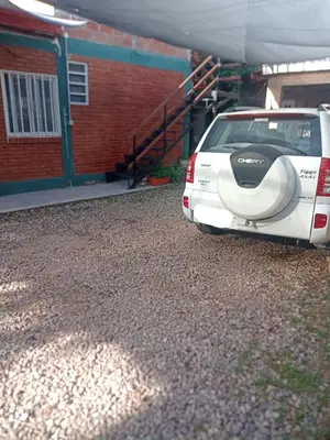 a white car parked in front of a building at Alojamiento Nonino in Villa Cura Brochero