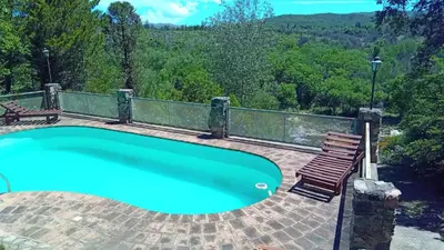 a swimming pool with a bench and a chair at Chalet Tala Huasi, Costa Rio, Pileta in Villa Icho Cruz