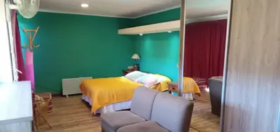 a bedroom with a bed and a green wall at Chalet Tala Huasi, Costa Rio, Pileta in Villa Icho Cruz