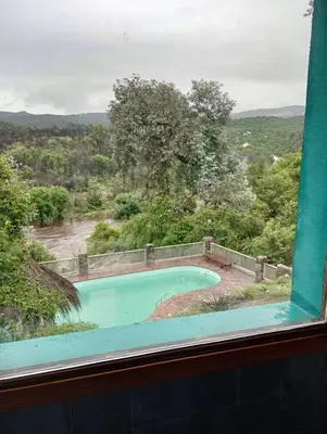 a view of a swimming pool from a window at Chalet Tala Huasi, Costa Rio, Pileta in Villa Icho Cruz