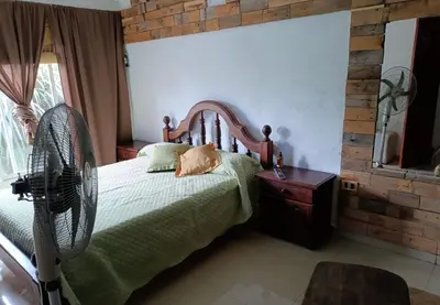 a bedroom with a bed and a fan at Mi casita en Embalse in Embalse