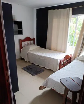 a bedroom with two beds and a window at Mi casita en Embalse in Embalse