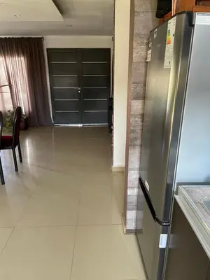 a kitchen with a stainless steel refrigerator in a room at Mi casita en Embalse in Embalse