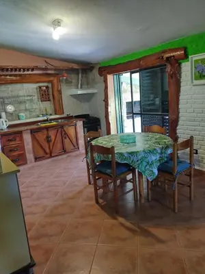 a kitchen with a table and chairs in a room at Tiempo libre in Villa Icho Cruz