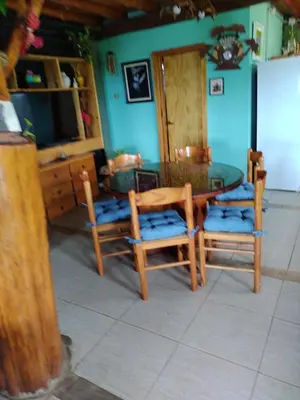 a dining room with a table and two chairs at Tiempo libre in Villa Icho Cruz