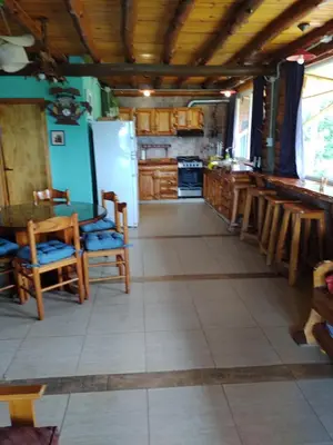 a kitchen with a refrigerator and some chairs in it at Tiempo libre in Villa Icho Cruz