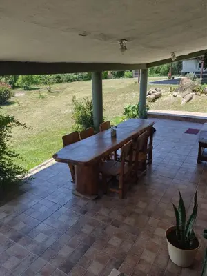 a wooden table and chairs on a patio at Tiempo libre in Villa Icho Cruz