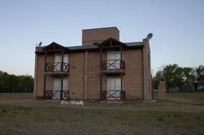a brick house with a tower on top of it at Complejo de cabañas- Lomas del Sol in Los Reartes