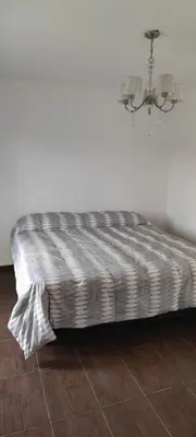 a bed in the corner of a room at Casa villa el diquecito in La Calera