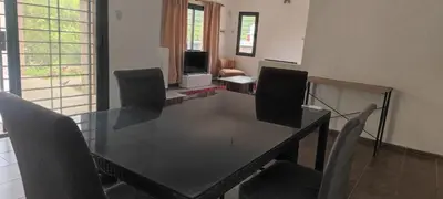 a dining room with a glass table and chairs at Casa villa el diquecito in La Calera