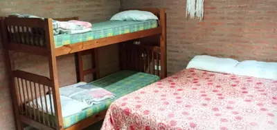 two bunk beds in a room with a bed at La Soñada in Villa Quillinzo