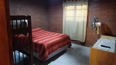 a bedroom with a bunk bed and a window at La Soñada in Villa Quillinzo