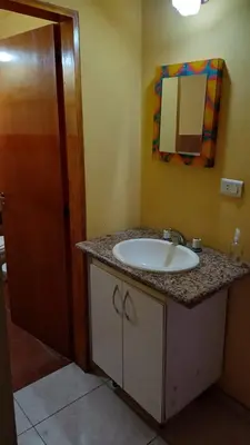 a bathroom with a sink and a mirror at La Soñada in Villa Quillinzo