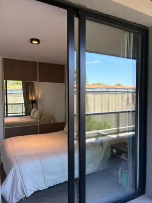 a bedroom with a bed and a large window at Complejo Las Pircas Alta Gracia in Alta Gracia
