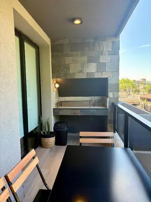 a dining room with a table and two chairs at Complejo Las Pircas Alta Gracia in Alta Gracia