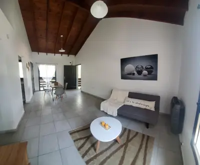 a living room with a couch and a table at departamento al pie de las sierras in Villa General Belgrano