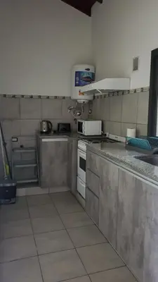 a kitchen with stainless steel counter tops and appliances at departamento al pie de las sierras in Villa General Belgrano