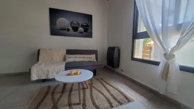 a living room with a couch and a table at departamento al pie de las sierras in Villa General Belgrano