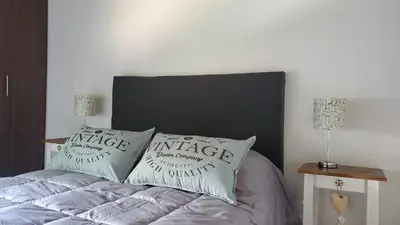 a bedroom with a bed with two pillows on it at departamento al pie de las sierras in Villa General Belgrano