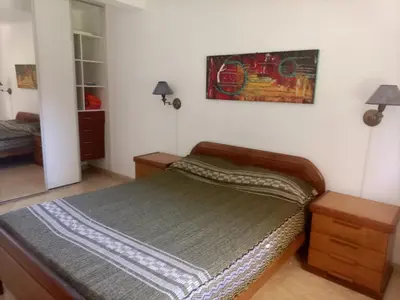 a bedroom with a bed and a picture on the wall at Departamento en Villa Carlos Paz in Villa Carlos Paz